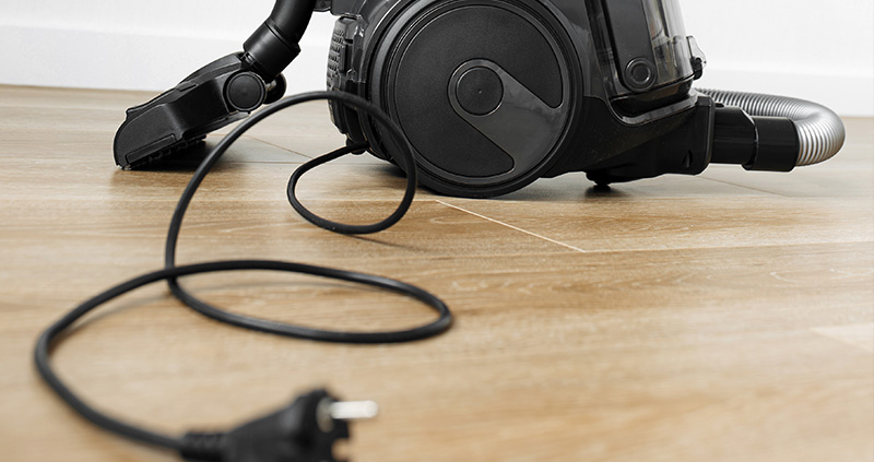 Staubsauger mit ausgerolltem Staubsaugerkabel